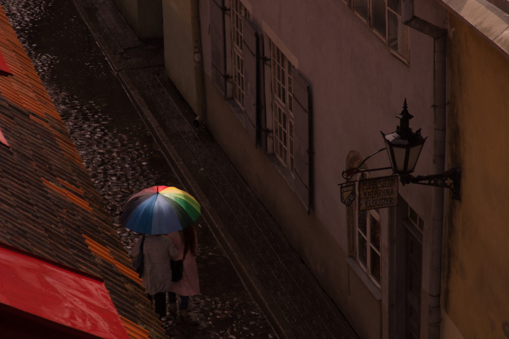 People with rainbow umbrella